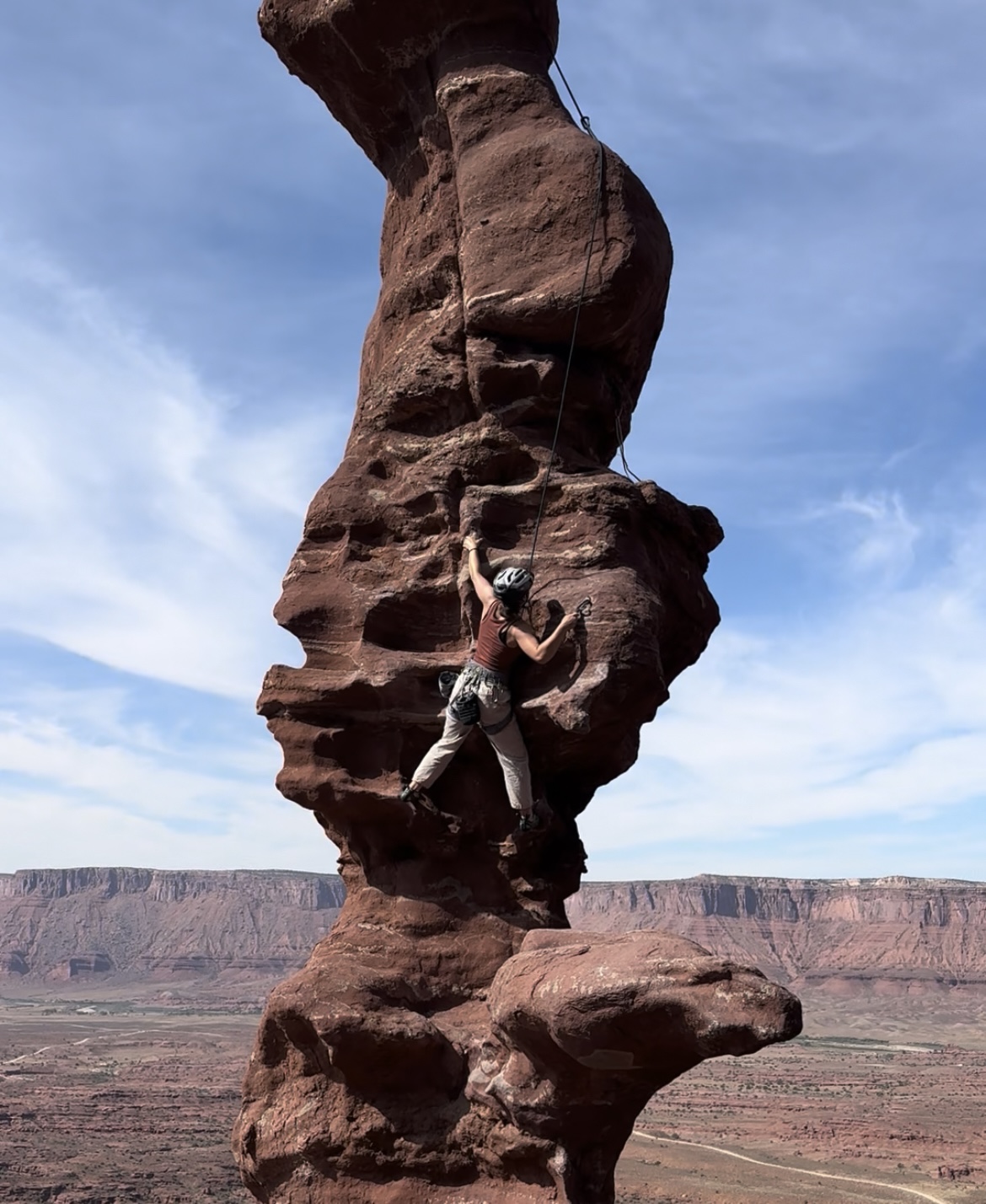 brianna climbing a rock